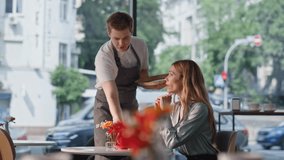 Lonely woman sitting cafe table with dreamy expression. Friendly restaurant waiter serving female client taking empty coffee cup. Pensive lady blonde thinking on life relaxing in cozy cafeteria alone. - Powered by Shutterstock - Get 15% off with code: PIKWIZARD15
