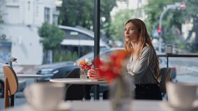 Pensive lady waiting date in modern restaurant looking on smartphone watch. Thoughtful beautiful woman sitting cafeteria table alone. Attractive female blonde relaxing at cozy cafe feeling lonely. - Powered by Shutterstock - Get 15% off with code: PIKWIZARD15