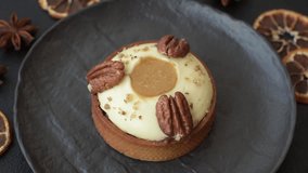 Sweet round tart with white citrus cream and pecans on a dark concrete background - Powered by Shutterstock - Get 15% off with code: PIKWIZARD15