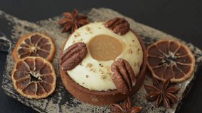 Sweet round tart with white citrus cream and pecans on a dark concrete background - Powered by Shutterstock - Get 15% off with code: PIKWIZARD15