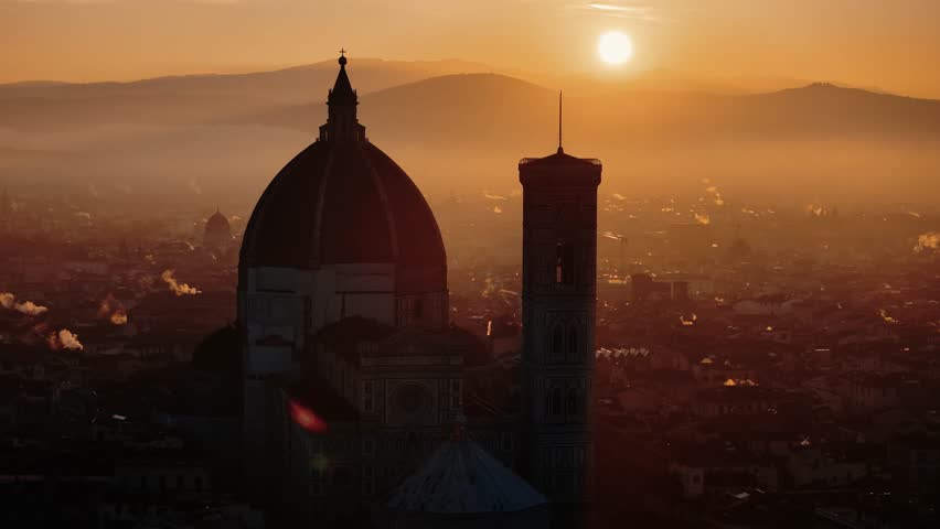 Aerial orbit around Florence Duomo as sunrise casts dramatic shadows