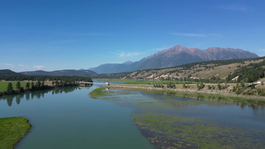 Aerial View of the Columbia River, Bridge, and Majestic Mountains in British Columbia