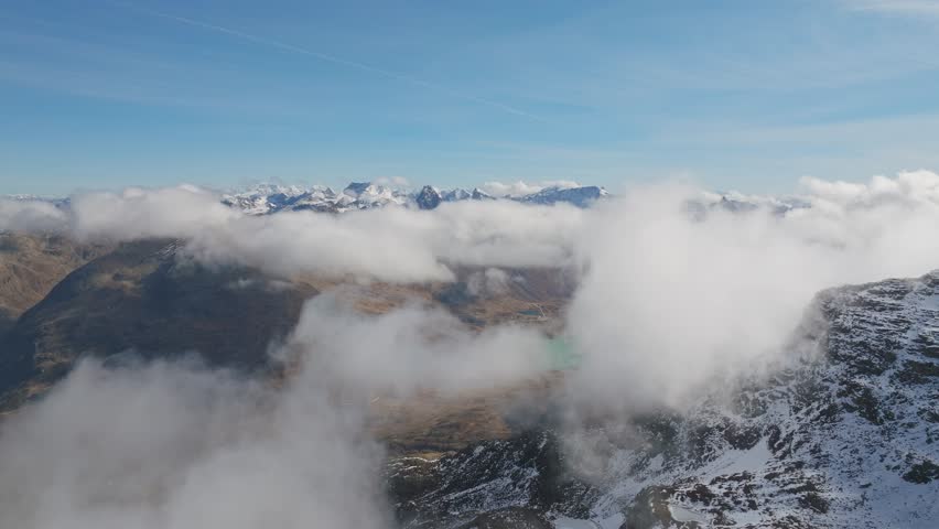 Swiss Alps covered in clouds, aerial view