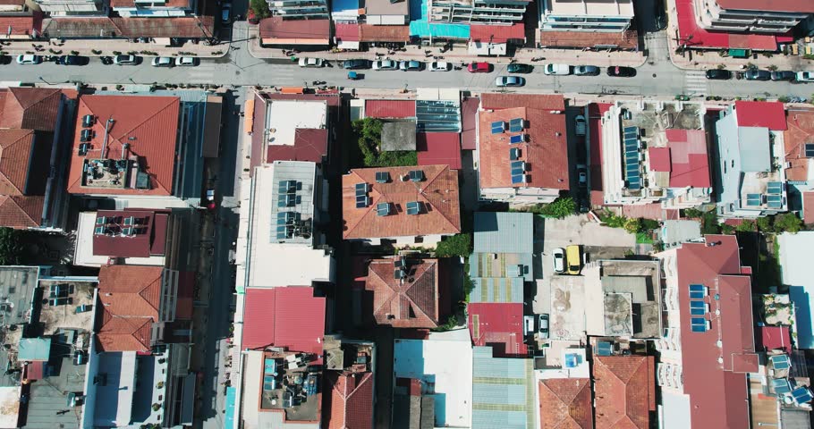Aerial view of Paralia cityscape showcasing vibrant architecture and vibrant streets in Greece, drone shot