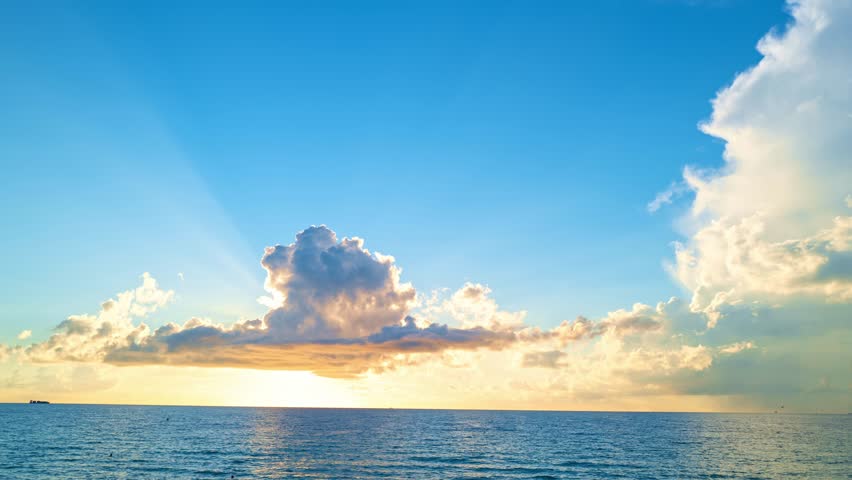 Timelapse Sunset with sun and clouds on blue and orange dramatic sky with sun rays. Night Sky timelapse. Moving clouds at sunset. Evening Clouds. Dusk twilight sky time lapse. Dramatic skies.