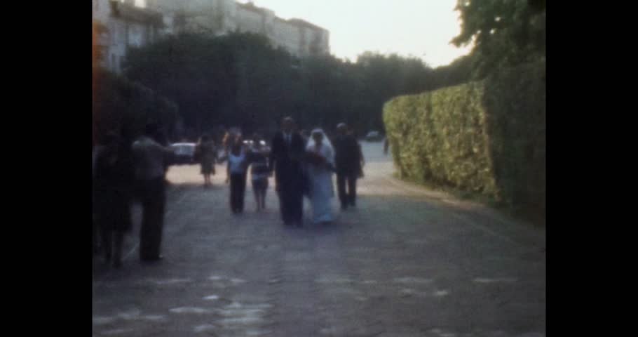 Bride and groom walking down the street, front view. Wedding ceremony, photographer, photo shoot. Archival video, film, 1970s, Ukraine, Kyiv.