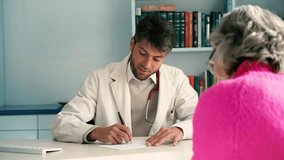 Doctor giving prescription to senior patient in medical office - Powered by Shutterstock - Get 15% off with code: PIKWIZARD15