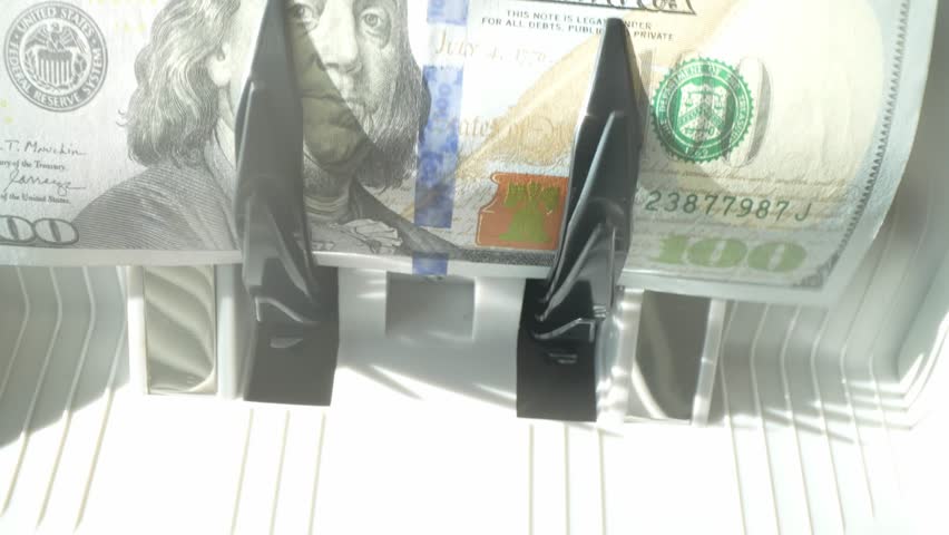 Cash money inside running banknotes counter. Banking and financial concept. Electronic money counter with new hundred dollars banknotes. Counter machine is counting 100 dollars banknotes.