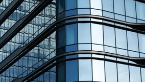 Modern walls are made of glass and steel with reflections of blue sky. - Powered by Shutterstock - Get 15% off with code: PIKWIZARD15