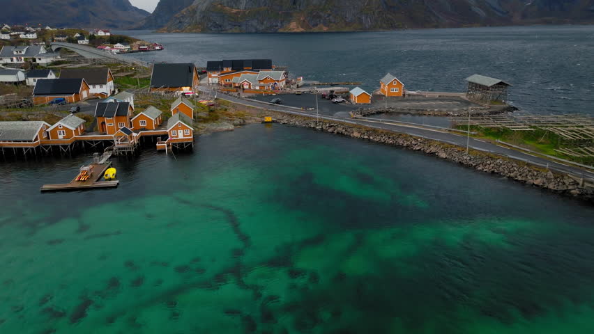 Panoramic drone shot of yellow fisherman Rorbuer cabins in the fishing village of Sakrisoy, Norway, Scandinavia