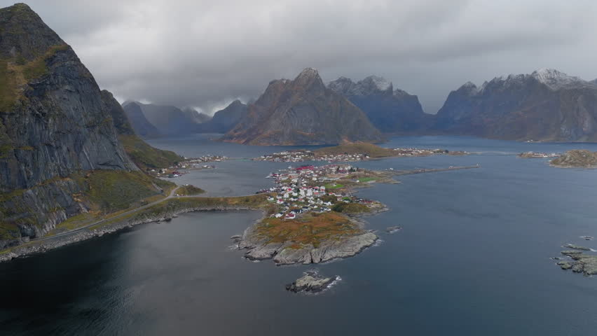 Slow panning drone shot of Reine village in Lofoten islands, Norway on a cloudy day