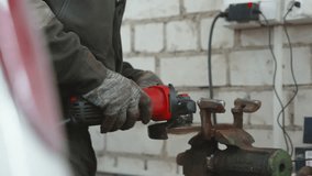 Professional mechanic grinding metal component with angle grinder, wearing safety glasses in workshop, demonstrating precision metalwork and automotive repair skills - Powered by Shutterstock - Get 15% off with code: PIKWIZARD15