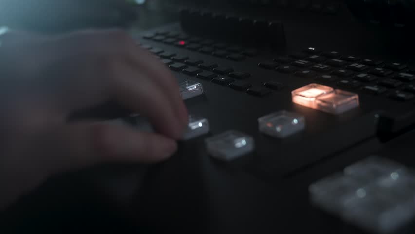 High-speed footage of a professional broadcast mixing console in action during a live production