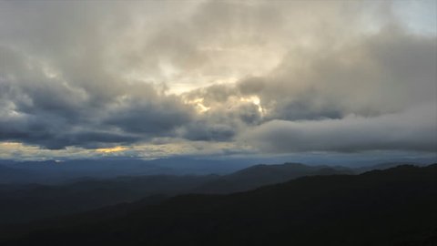 Full HD-Time lapse fast moving cloud on top of the mountain. Cloud fads to darkness before storm coming.
