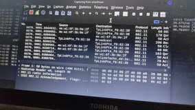 A close-up of a laptop screen running network packet analysis software on a Linux operating system. The interface displays data packets, sources, and protocols, commonly used for cybersecurity - Powered by Shutterstock - Get 15% off with code: PIKWIZARD15