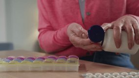 Senior elegant woman sorting pillbox at table. Aged woman putting vitamins in pills organizer. Older organized woman doing health care and therapy. Female elegant retired using medicine container - Powered by Shutterstock - Get 15% off with code: PIKWIZARD15