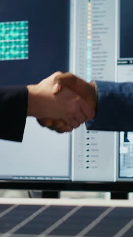 Vertical video Factory manager welcoming shareholder, shaking hands, working together to expand industrial plant production. Man doing greeting handshake with investor, developing business model