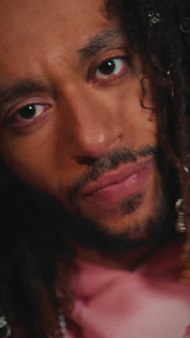 Big dark eyes of sad african man with trendy dreadlocks, closeup view of male face, vertical video. Emotions and feelings, depressed and sad male person, black guy looking at camera, human appearance