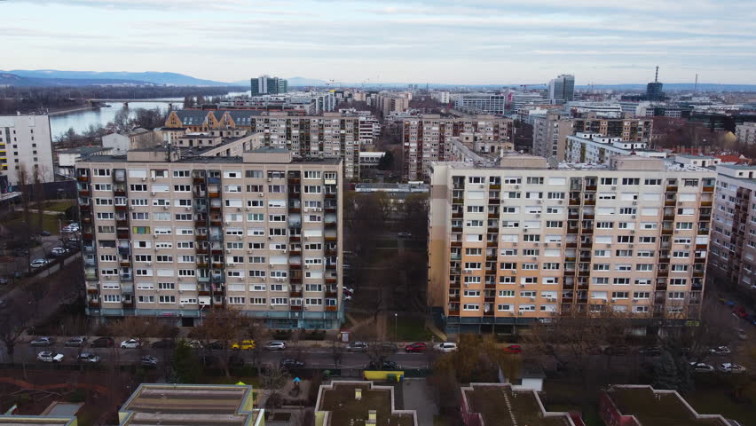 Aerial establishing Budapest residential area, buildings, roads, and green spaces in city, dense urban buildings
