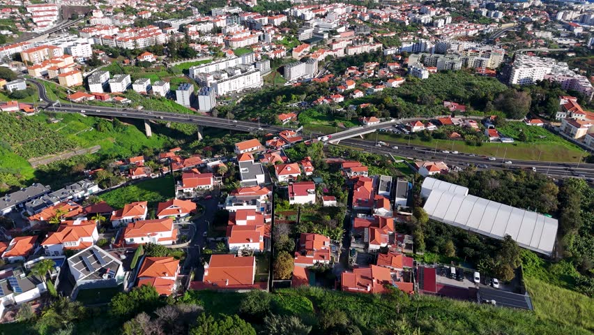 Cinematic Aerial Reveal of Funchal Cityscape on a Sunny Day with The Atlantic Ocean in the Background, Madeira
