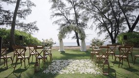 Wedding decor beach set up seaside floral arch. Wedding western detail wood chairs. - Powered by Shutterstock - Get 15% off with code: PIKWIZARD15