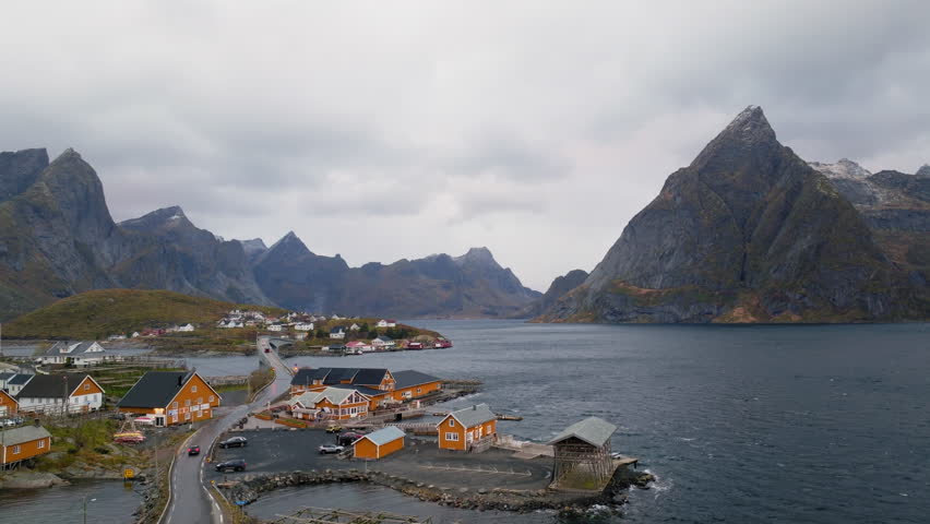The famous yellow cabin with Olstind mountain in Lofoten islands near to Reine village on Sakrisøy island