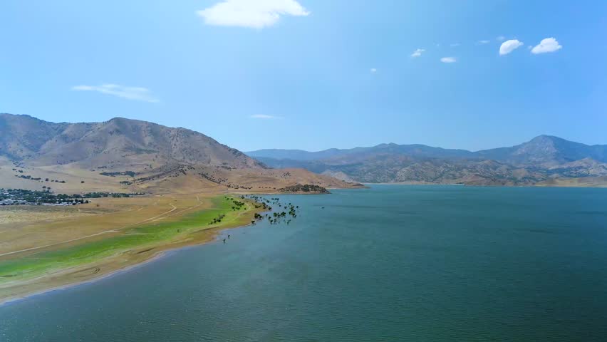 Lake Isabella, Sierra Nevada, Kern County, California - A Deep Blue Lake Amid Golden Hills and Rugged Mountains - Drone Flying Forward