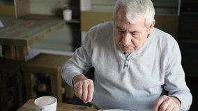 Happy senior man eating a scramble on a white plate with vegetables. Elderly male using knife and fork to cutting meal, has a breakfast. Balanced diet, cooking, culinary. Food concept. Old person
 - Powered by Shutterstock - Get 15% off with code: PIKWIZARD15