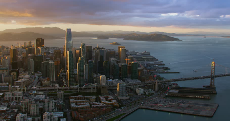 Amazing aerial view of San Francisco skyline. Flyover the Pacific ocean with several ships. Famous skyscrapers over a blue sky. Shot on Red weapon 8K. California, United States.