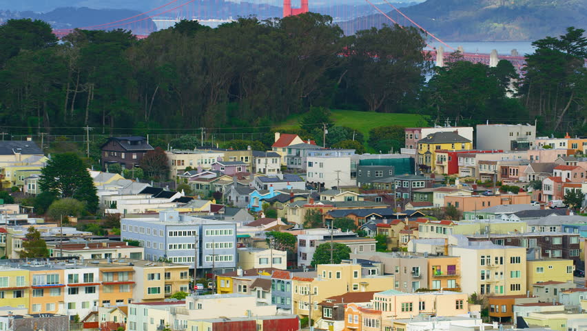 Aerial view of the magnificent Golden Gate Bridge with a cargo ship passing under it. This bridge connects the San Francisco peninsula to Marin County. US route 101 and SR 1 full of cars. Red 8K.