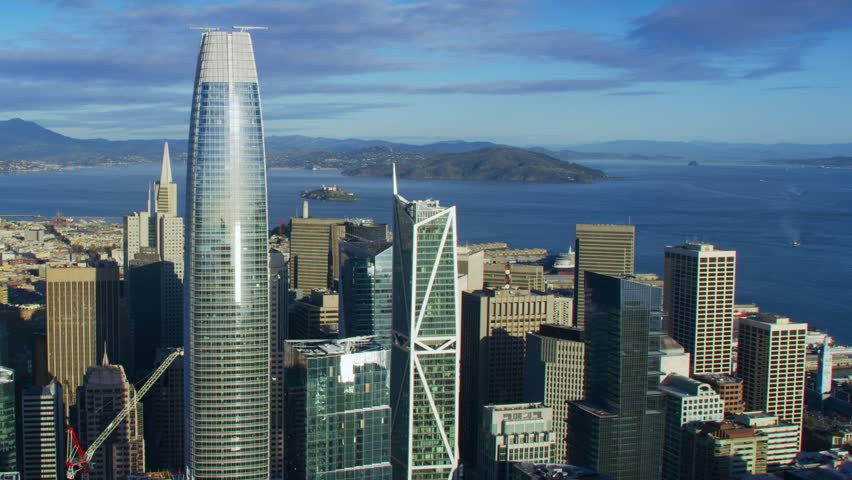 Interstate 80 full of traffic. Aerial view of San Francisco skyline. Famous skyscrapers over a blue sky. California, United States. Shot on Red weapon 8K.