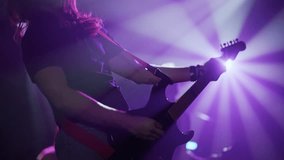 Passionate guitarist performing electric guitar riff under vibrant purple lights, embodying raw musical energy during intense stage performance - Powered by Shutterstock - Get 15% off with code: PIKWIZARD15