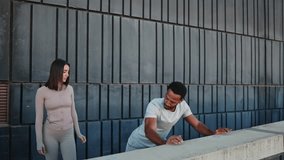 Personal trainer guiding man doing incline push-ups on wall - Powered by Shutterstock - Get 15% off with code: PIKWIZARD15