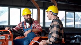 Two factory workers wearing hard hats are having a conversation next to a forklift in a warehouse or industrial setting - Powered by Shutterstock - Get 15% off with code: PIKWIZARD15