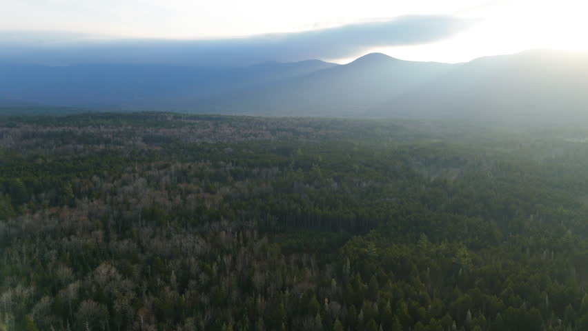 Stunning aerial view beautifully showcases the vibrant fall foliage surrounding Mount Washington, blending an enchanting and captivating array of rich colors with its breathtaking scenic beauty