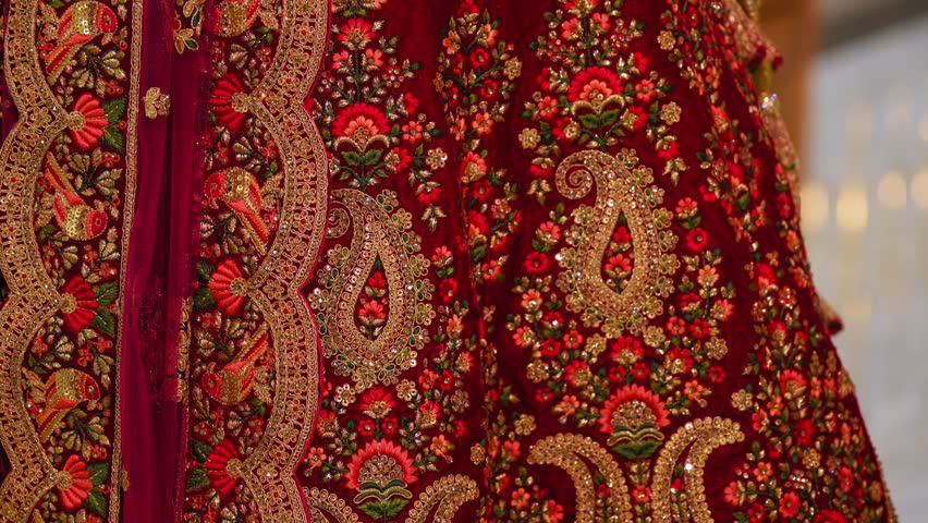 Elements of Hindu wedding dress. Traditional red dress with beautiful golden embroidering elements. 
