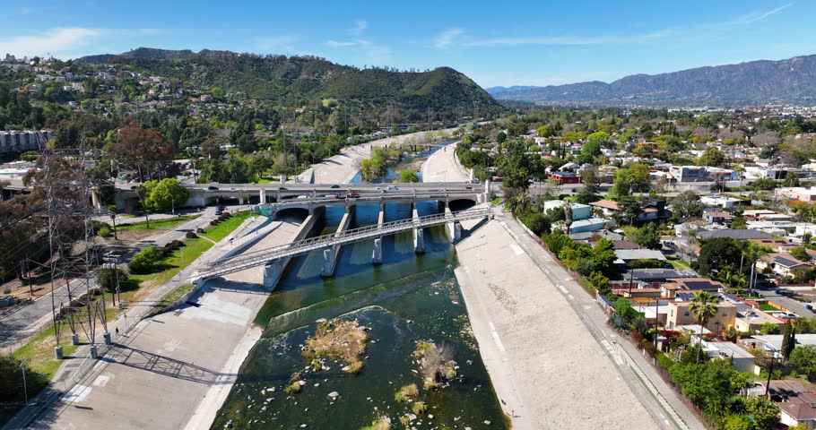 Glendale Narrows, LA River, Los Angeles, California, USA, March 19th 2025, Water flows down the Glendale Narrows through rocks and trees surrounded by pavement. 