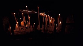 A collection of burning candles inside Notre-Dame de la Garde in Marseille. The warm glow of the flames illuminates the dark interior, creating a peaceful and spiritual atmosphere in this church. - Powered by Shutterstock - Get 15% off with code: PIKWIZARD15