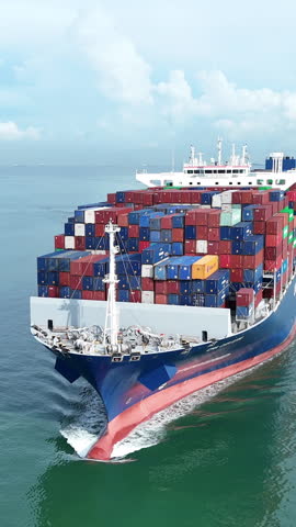 Cargo container ship carrying container and running out international container port customs shipyard sea port concept smart logistic service. Front view