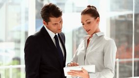 Analyzing financial data, business professionals using tablet with animation overlay. Finance, analysis, digital, corporate, strategy, technology - Powered by Shutterstock - Get 15% off with code: PIKWIZARD15