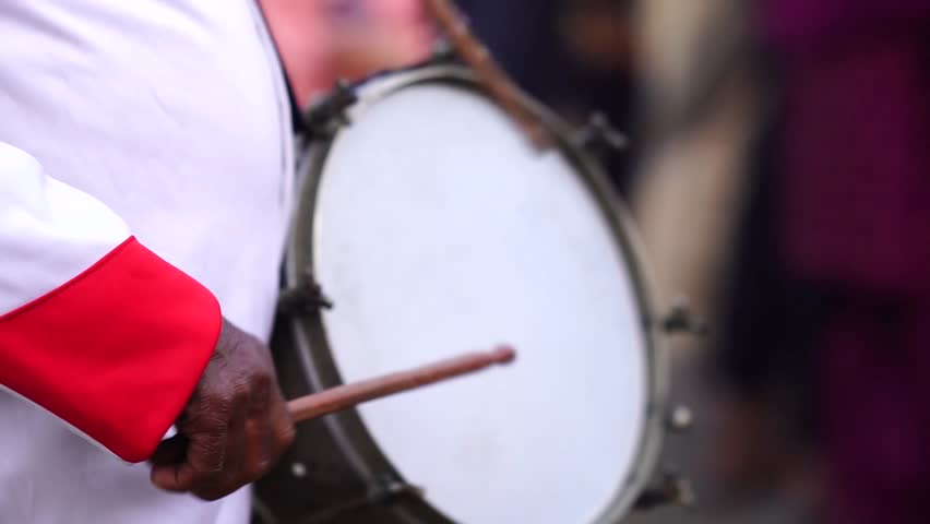 Close-up of a traditional Indian drummer playing a dhol drum