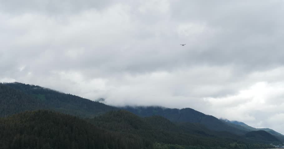 Waterplane flying over Juneau, Alaska, in a rainy day.