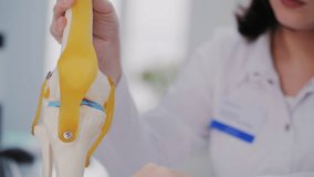 Doctor Explaining Knee Joint Structure with Model - Powered by Shutterstock - Get 15% off with code: PIKWIZARD15