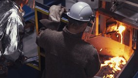 High amounts of molten steel are spilling out of the industrial furnace. Molten steel is extracted from the induction furnace at the factory. Molten steel flowing out of a burning furnace. Production. - Powered by Shutterstock - Get 15% off with code: PIKWIZARD15