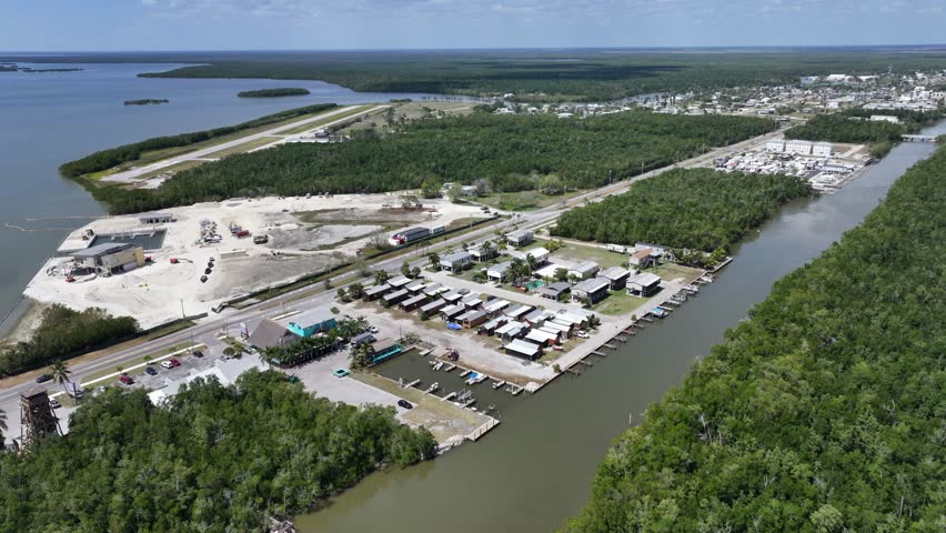 Flying forward from Everglades City south part to Downtown Everglades City - located next to Lake Placid in Florida -   with Everglades National Park in background - 4k aerial video footage