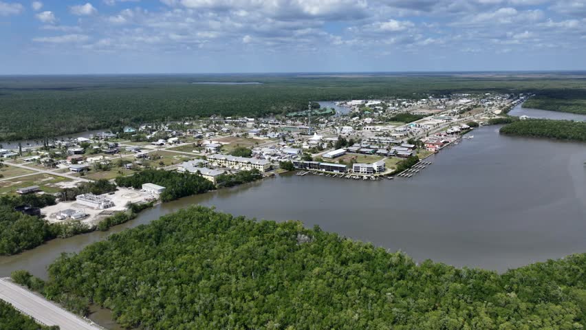 Flying backwards from Downtown Everglades City - located next to Lake Placid in Florida - southbound with Everglades National Park in background - 4k aerial video footage