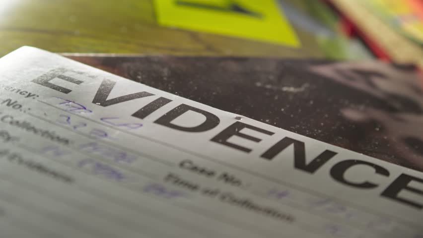Forensic Evidence report sits on crime desk investigation board SLIDE shot