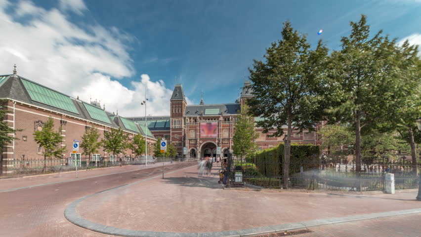 Hyperlapse of the Rijksmuseum, a famous tourist attraction in Museum Square, Amsterdam. The national museum of the Netherlands, dedicated to Dutch art and history timelapse. People walking on a path