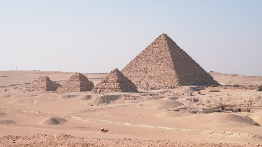 Iconic Pyramids of Giza with a Cart Crossing the Desert in 4K