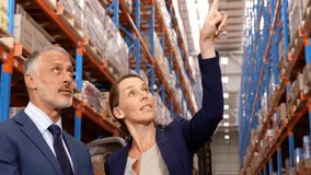 In warehouse, business professionals analyzing network connections using animation tools. Technology, digital, analysis, software, collaboration, innovation - Powered by Shutterstock - Get 15% off with code: PIKWIZARD15